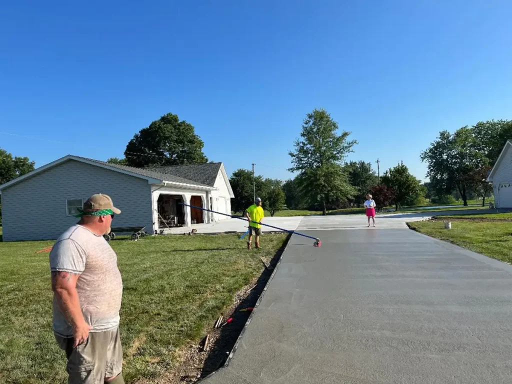 Workhorse Concrete, professionals smoothing out poured concrete driveway - Pana IL